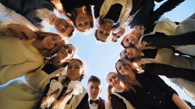 Happy friends connected in a ring together. View from the bottom. The concept of strong friendship