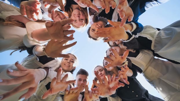Happy friends connected in a ring together. View from the bottom. The concept of strong friendship