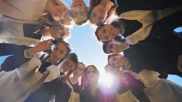 Happy friends connected in a ring together. View from the bottom. The concept of strong friendship