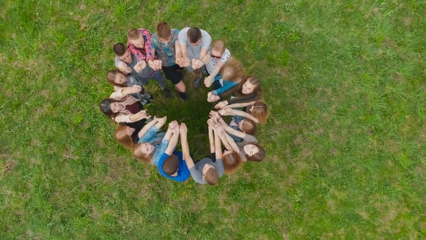 Friendly friends join hands together. Aerial view
