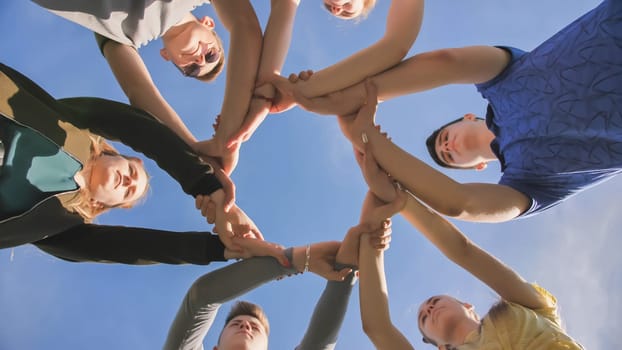 Partnership and unity concept: people holding wrists of each other.