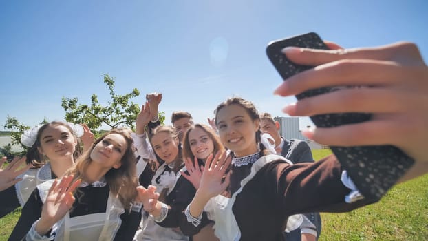 Happy high school graduates take a selfie on a sunny day