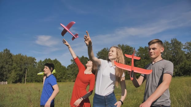 Jolly friends launch a toy airplane into the sky