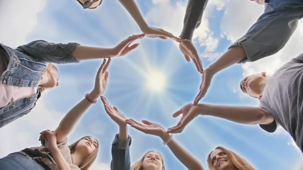 Conceptual symbol of cooperation diverse hands making a circle. Students help each other