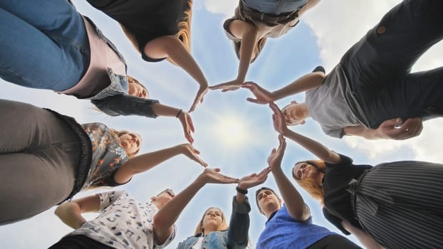 Conceptual symbol of cooperation diverse hands making a circle. Students help each other