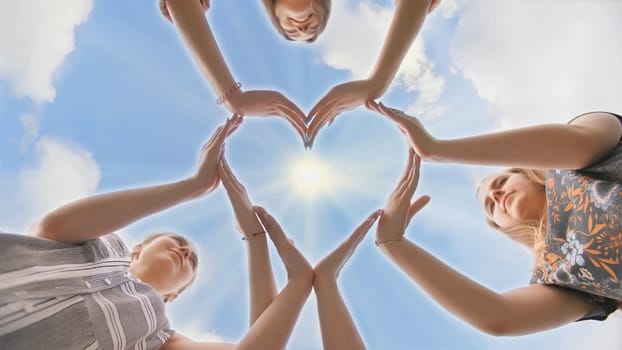 A group of youth makes a heart shape out of their hands