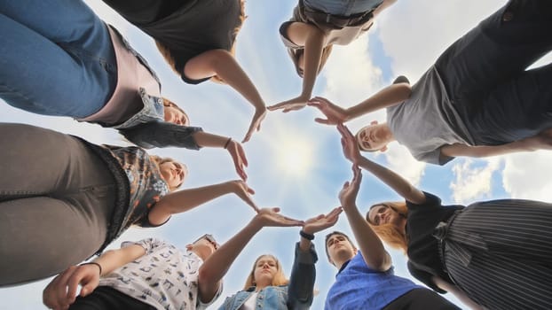 Conceptual symbol of cooperation diverse hands making a circle. Students help each other