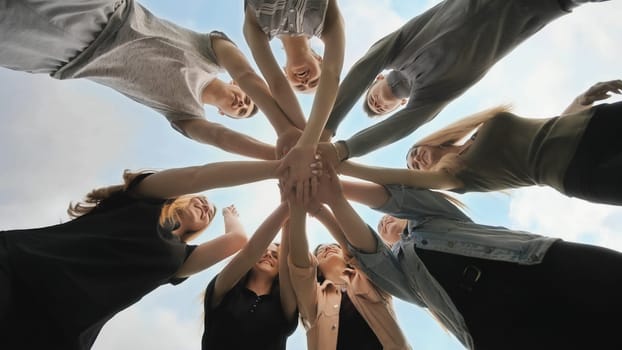 Friends join their hands as a sign of their strong friendship