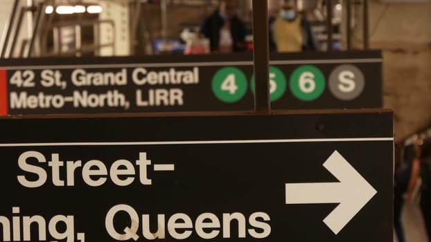 New York City, United States - 29 Aug 2023: Subway station interior, underground metropolitan platform. Public metro transport. Railway passenger traffic. Text sign: Grand Central, 42, Queens. People.