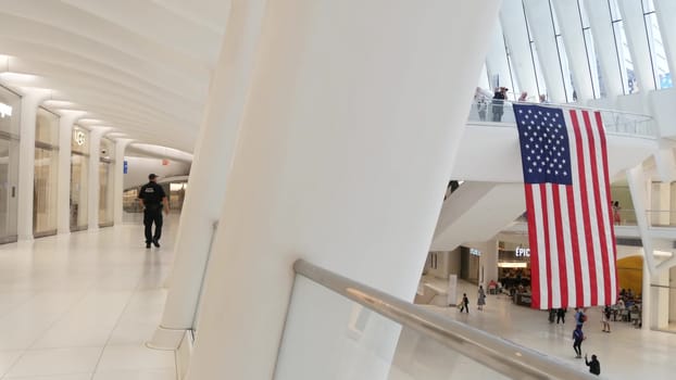 New York City, United States - 10 Sept 2023: World Trade Center Oculus building. Manhattan Downtown Financial District, USA urban life. People. September 11 remembrance american flag. Police officer.