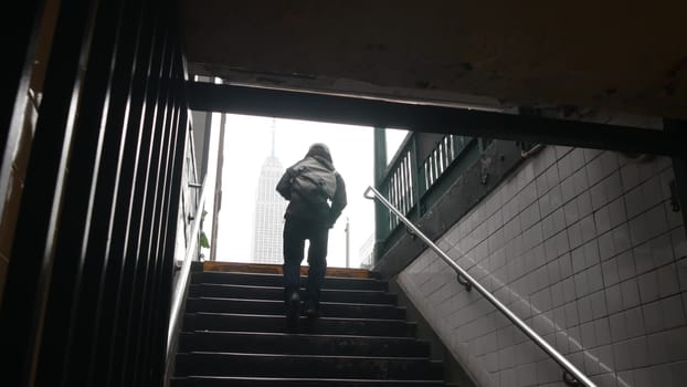 New York City, United States - 30 Aug 2023: Underground subway, metro stairway. Empire State building. Metropolitan entrance. Manhattan Midtown financial business district. African american black man.