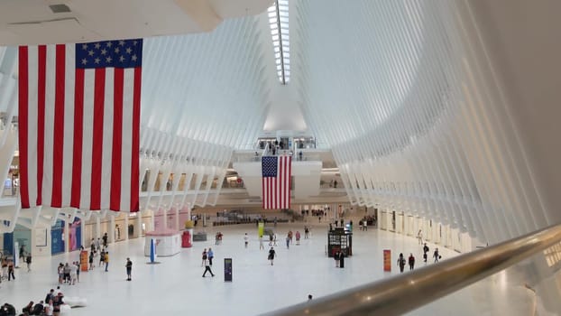 New York City, United States - 10 Sept 2023: World Trade Center Oculus transport hub architecture. Manhattan Downtown Financial District, USA urban life. People. September 11 remembrance american flag