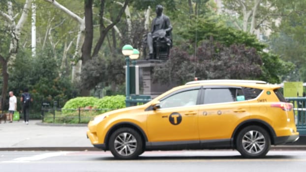 New York City, United States - 8 Sept 2023: Manhattan Midtown Broadway, 23 street, 5 avenue crossroad intersection. Madison Square Park by Flatiron Building, USA. People, subway and yellow taxi. Rain.
