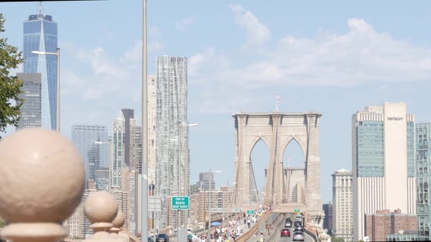 New York City, United States - 3 Sept 2023: Cars on Brooklyn Bridge from Manhattan downtown. Financial district skyline cityscape. Road traffic, people, architecture. World Trade Center skyscraper.