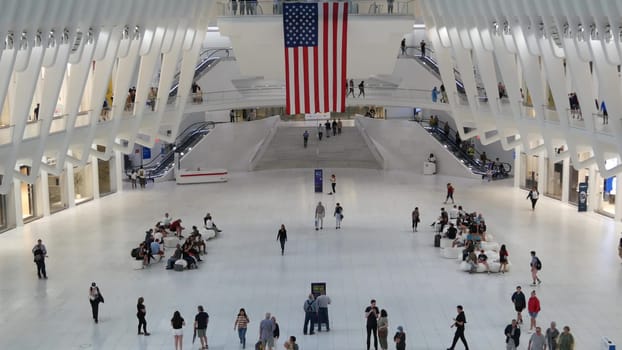 New York City, United States - 10 Sept 2023: World Trade Center Oculus transport hub architecture. Manhattan Downtown Financial District, USA urban life. People. September 11 remembrance american flag