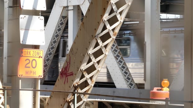 New York City, United States - 14 Sept 2023: Manhattan Bridge to Brooklyn Dumbo. American subway metro train from pedestrian path. Public railway transport. Railroad traffic and architecture in USA.