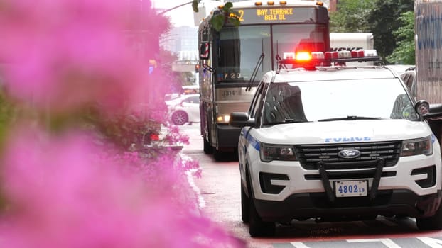 New York City, United States - 29 Aug 2023: Police patrol car, USA NYPD, 911 vehicle on Manhattan Midtown 34th street. American cop auto siren light on avenue. Urban traffic, road transport scene. Bus