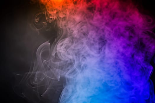 colorful smoke on dark background. artistic colorful background