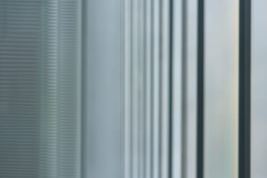 blurred abstract grey glass wall from building background. abstract architectural theme