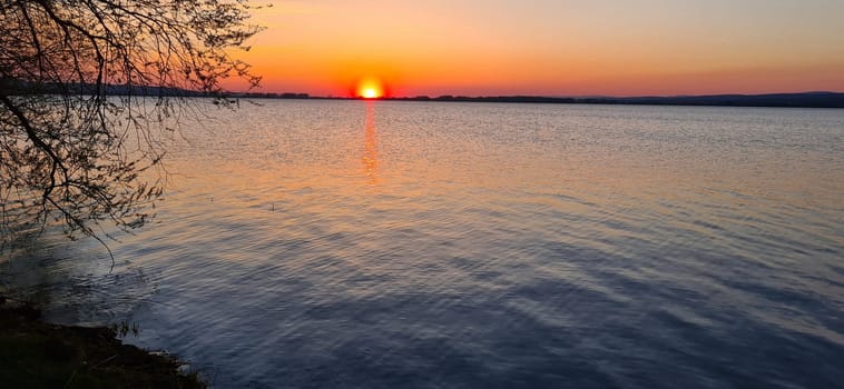 Beautiful sunset at the lake with a motorhome on a camping holiday in Sweden