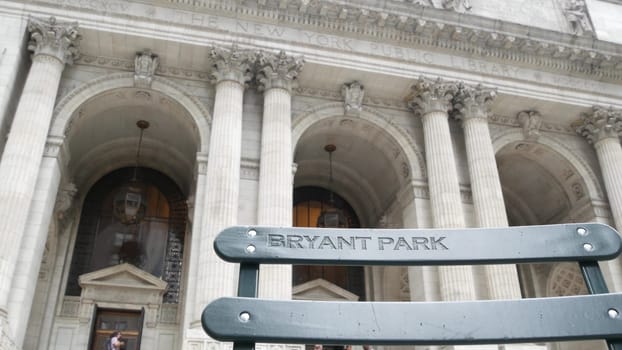 New York City, United States - 13 Sept 2023: Manhattan Midtown Bryant Park. Public library building architecture, 42 street and 5th Fifth 5 avenue. USA landmark. Facade exterior and sign on chair.