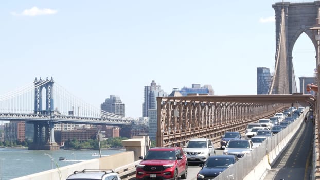 New York City, United States - 3 Sept 2023: Cars on Brooklyn Bridge, Manhattan Bridge and Dumbo view. Rush hour road traffic jam and architecture. Iconic landmark on East River. Travel USA.