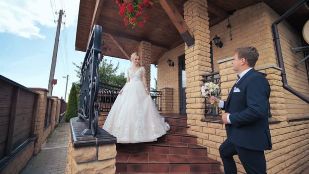 The groom meets his bride and gives her a bouquet