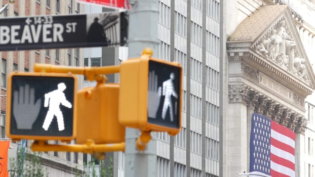 New York City, United States - 9 Sept 2023: Manhattan Downtown Financial District. American flag, Wall street. Broad and Beaver corner road sign. Stock Exchange building, USA Stock Market. Crossroad.