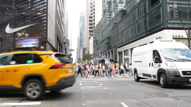 New York City, United States - 11 Sept 2023: Manhattan Midtown street, Fifth 5 avenue, 5th ave, American road car traffic, Yellow taxi cab. People pedestrians, zebra crosswalk, crossroad intersection.