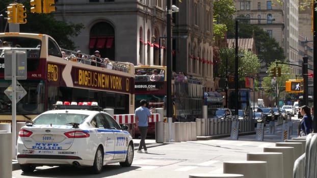 New York City, United States - 31 Aug 2023: Police patrol car, USA NYPD 911 vehicle, Manhattan Downtown Church street, Oculus. American cop auto. Urban road traffic, people crossing on zebra. Big Bus.