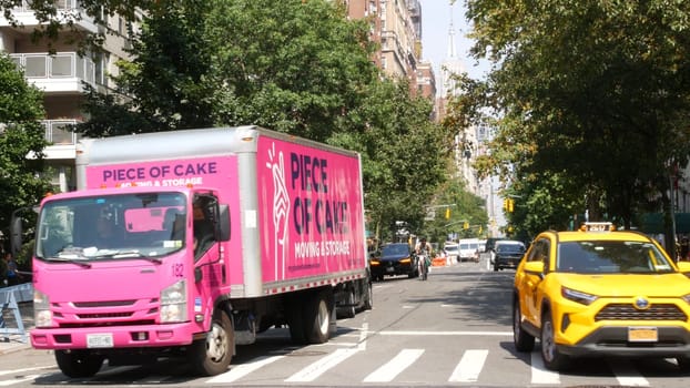 New York City, United States - 8 Sept 2023: Manhattan Greenwich Village street, 5th Fifth 5 avenue near Washington Square Park. American road car traffic, people. Yellow taxi. Piece of Cake pink truck
