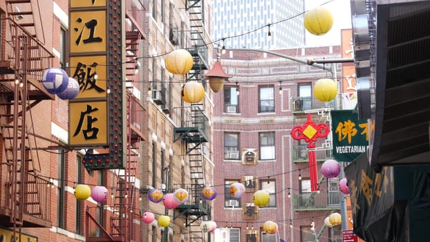 New York City, United States - 14 Sept 2023: Manhattan Chinatown Pell street. Chinese culture, ethnic district architecture, USA. Red brick buildings, paper lanterns and hieroglyph signs. Little China