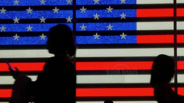 New York City, United States - 5 Sept 2023: Times Square, Manhattan Midtown Broadway street, USA. American flag, NYC urban life. Military island, army recruiting. People pedestrians silhouettes, crowd