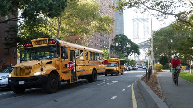 New York City, United States - 7 Sept 2023: Yellow School Bus, Manhattan bridge, schoolbus truck, city street. Children education and USA transportation. American residential district school shuttle.
