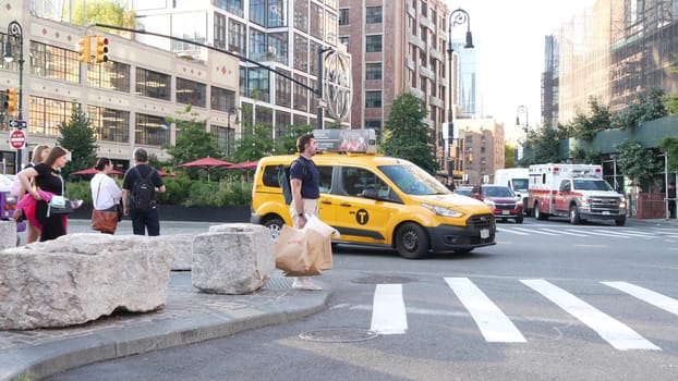 New York City, United States - 2 Sept 2023: Manhattan Midtown street, Chelsea, 9 avenue. Meatpacking district road car traffic, USA. People, yellow taxi cab. FDNY emergency ambulance paramedic truck.