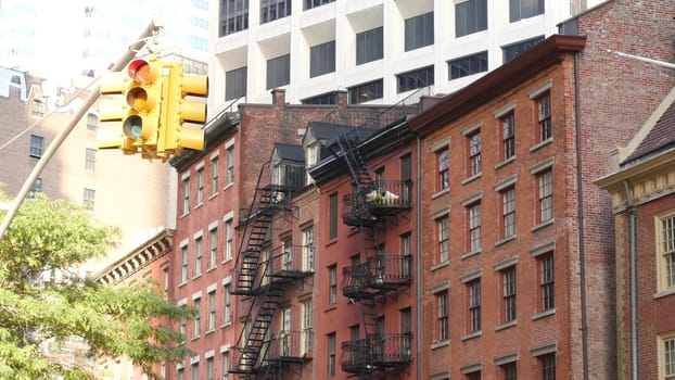 New York City, United States - 31 Aug 2023: Street crossroad, traffic light, transport road intersection. Residential building. Red brick house, fire ladder. Manhattan downtown financial district FiDi