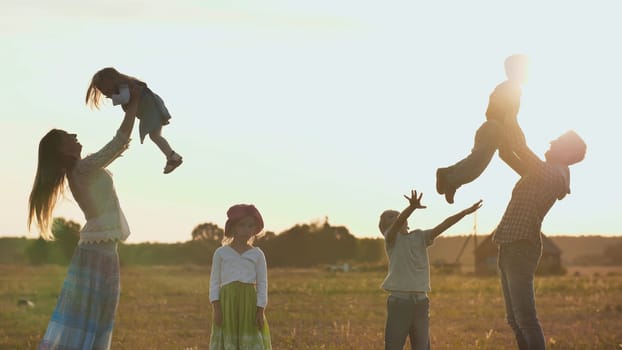 Happy parents of 4 children toss up their children