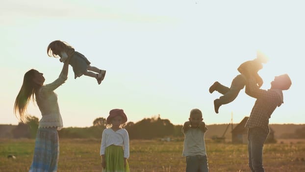Happy parents of 4 children toss up their children