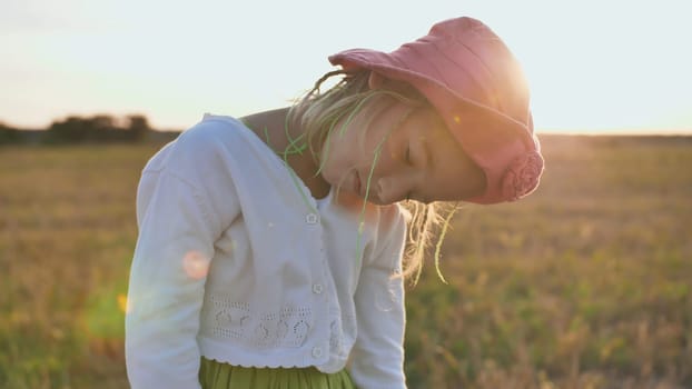 Little girl sleeps standing in the evening at sunset