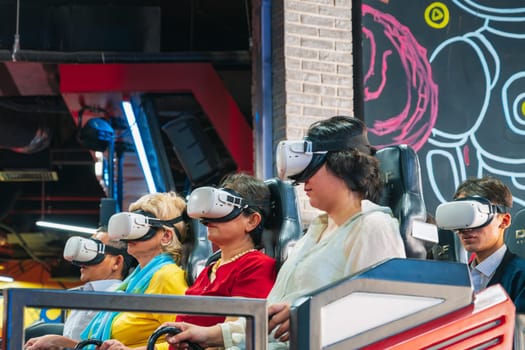 Happy adult woman wearing 3D virtual reality glasses is having fun at an amusement park on Vinpearl Island in Nha Trang. Nha Trang, Vietnam - March 6, 2025
