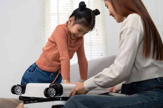 The image showcases a little girl eagerly involved in packing, offering a glimpse into the excitement and bonding moments that make travel preparations special.