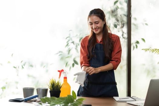 This happy gardener enjoys her time with plants, demonstrating the happiness that comes from sustainable gardening practices and nurturing nature.