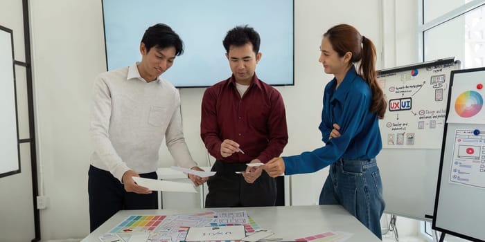 In a workshop setting, team members actively share and sketch ideas, enhancing the design process for an upcoming project, focused on collaboration and innovation.
