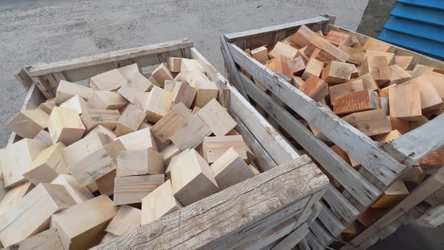 Two wooden crates full of chopped firewood, ready for winter heating