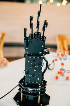 Cyborg mechanical arm in action as a black real robot hand presses on a table. Illustrating futuristic intelligence development and innovative technological evolution.