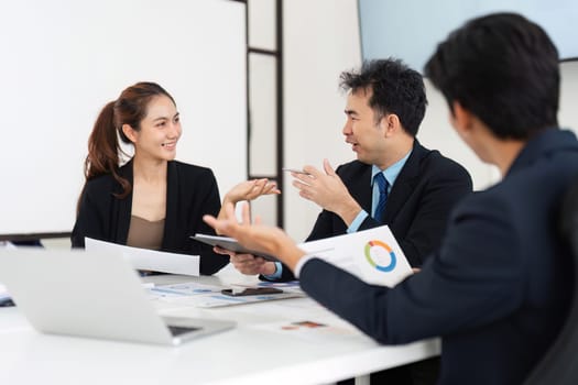 A productive team meeting where a group discusses strategies, supported by visual aids, fostering an environment of innovation and collaboration.