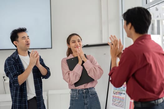 In a moment of genuine connection, team members express gratitude and joy after achieving a breakthrough in their creative project during a friendly meeting.