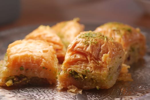 Delicious baklava pieces filled with nuts and drizzled with syrup