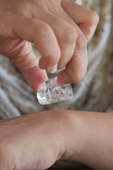 Cool relief is given to skin by using ice on a warm day at home.