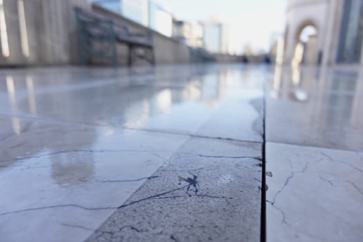 wet marble floor at urban plaza .